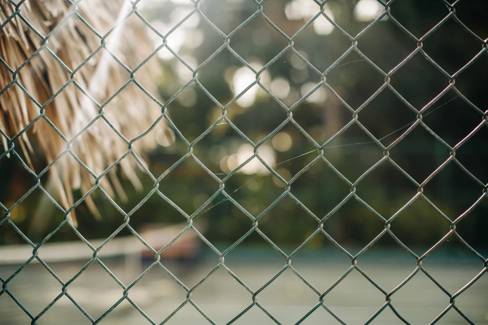 Close-up view of galvanized chain-link fence mesh for perimeter fencing